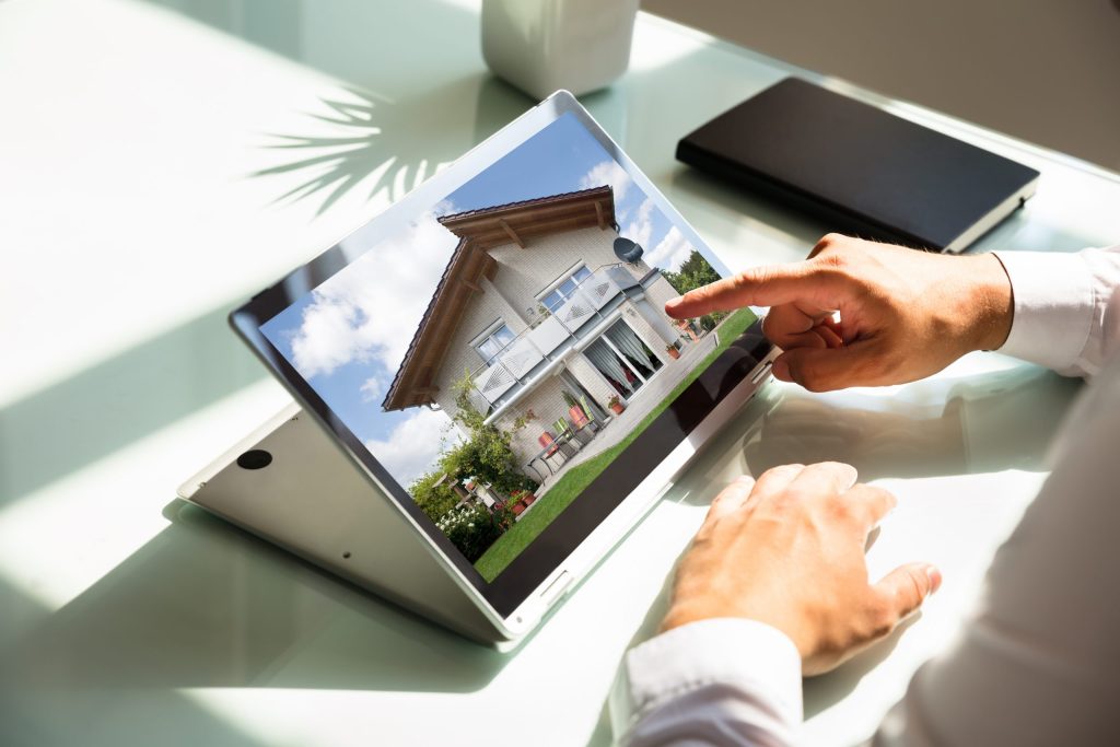 Close Up,of,businessman's,hand,checking,house,on,laptop